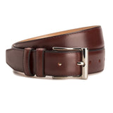 Meermin burgundy Naturcalf boxcalf belt, coiled to show buckle and loops, nickel-plated solid brass buckle in focus