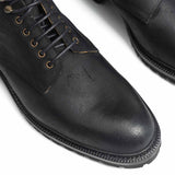 Meermin black waxy commander Service boots, close-up top view of toe cap, lace eyelets, and cleated rubber sole edge